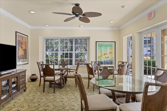 dining area with french doors, ceiling fan, crown molding, and light colored carpet