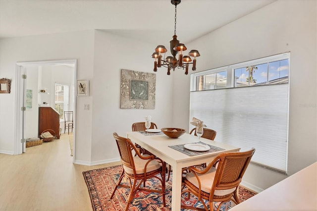 dining room featuring a chandelier and wood-type flooring