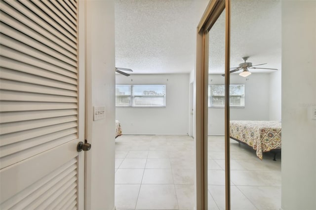 interior space with a textured ceiling and light tile patterned floors