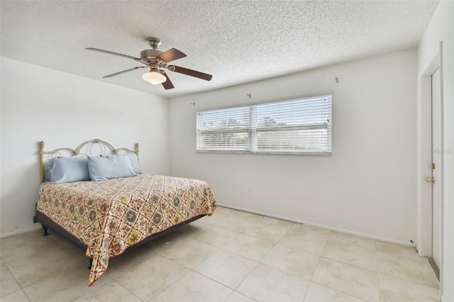 bedroom featuring a textured ceiling and ceiling fan