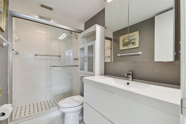 bathroom with tile patterned floors, vanity, toilet, and an enclosed shower