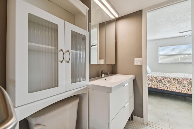 bathroom featuring toilet, vanity, and tile patterned floors