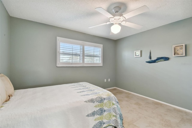 bedroom with a textured ceiling and ceiling fan