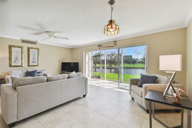 tiled living room featuring ceiling fan, a textured ceiling, and ornamental molding