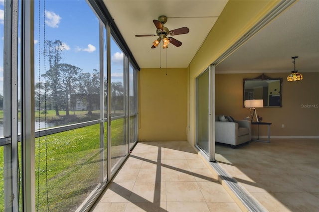 unfurnished sunroom featuring a wealth of natural light and ceiling fan