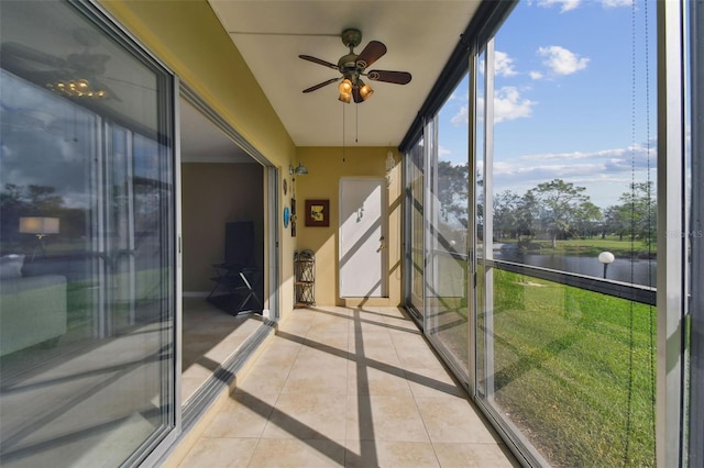 unfurnished sunroom with ceiling fan