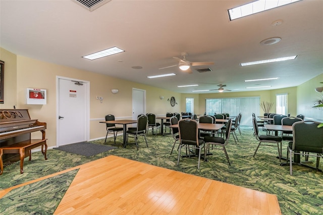 dining area featuring wood-type flooring and ceiling fan