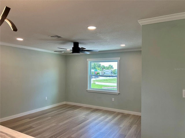 unfurnished room featuring ceiling fan, light wood-type flooring, and crown molding