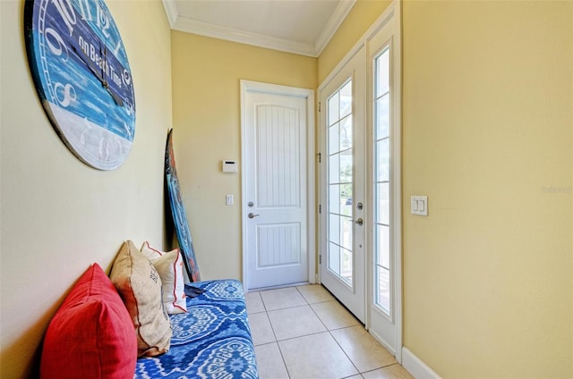 tiled foyer entrance with crown molding