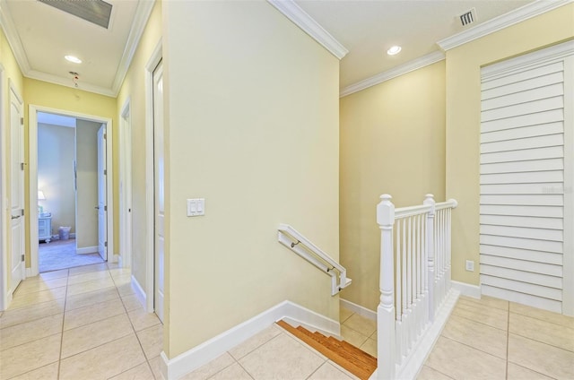 hallway with crown molding and light tile patterned floors