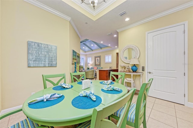 tiled dining room with ornamental molding and vaulted ceiling