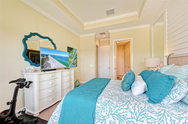 bedroom with ornamental molding and a tray ceiling