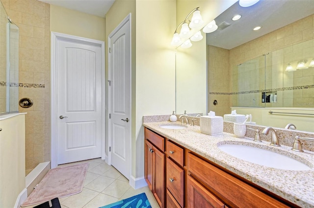 bathroom with vanity, tile patterned floors, and tiled shower