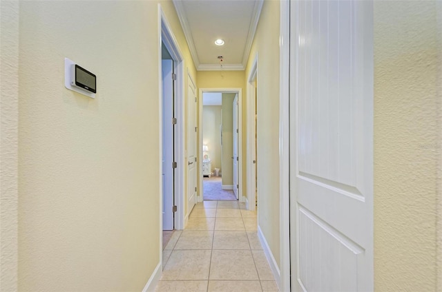 hall featuring ornamental molding and light tile patterned floors