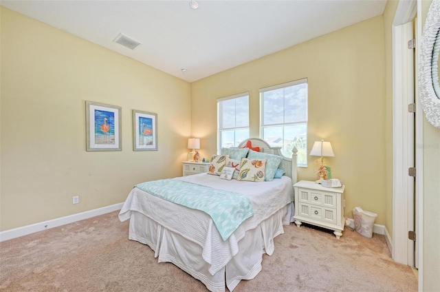 bedroom featuring light colored carpet