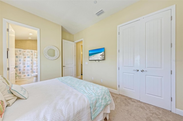 bedroom featuring light carpet and a closet