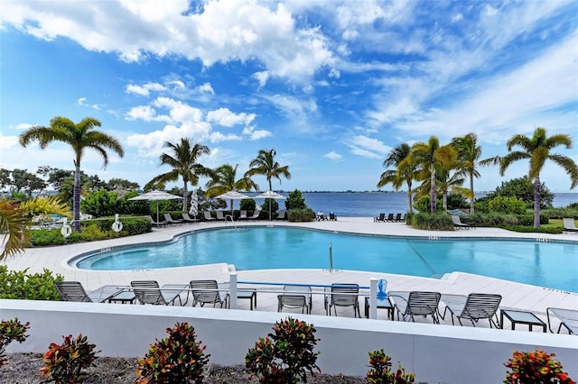 view of pool featuring a patio and a water view