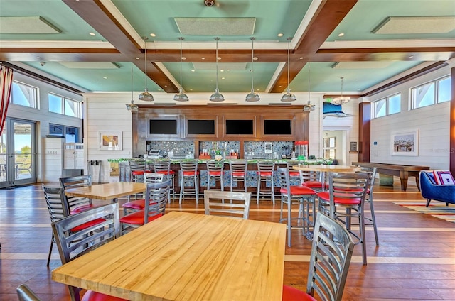 dining area featuring dark hardwood / wood-style floors, beam ceiling, and coffered ceiling