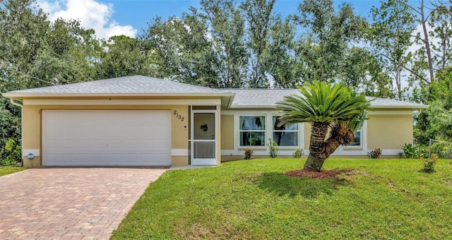 ranch-style house featuring a garage and a front lawn