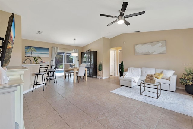 living room featuring light tile patterned flooring, ceiling fan, and vaulted ceiling