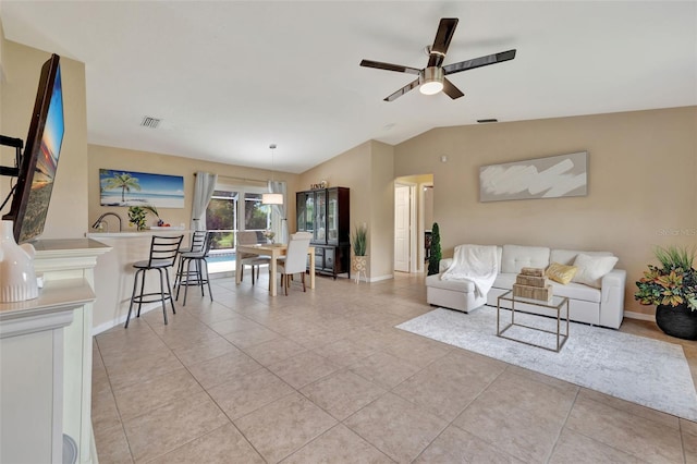 living room featuring vaulted ceiling, light tile patterned floors, and ceiling fan