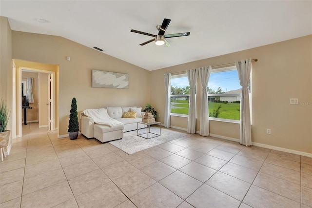 unfurnished living room with ceiling fan, lofted ceiling, and light tile patterned flooring