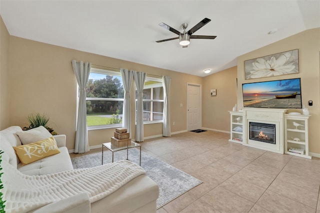 living room featuring ceiling fan, light tile patterned floors, and vaulted ceiling