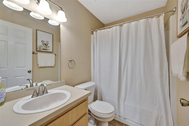 bathroom featuring curtained shower, vanity, and toilet