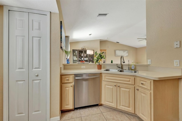 kitchen featuring lofted ceiling, dishwasher, kitchen peninsula, sink, and decorative light fixtures