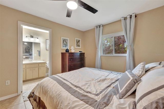 bedroom with ensuite bathroom, ceiling fan, and light tile patterned floors