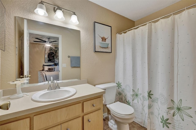 bathroom with toilet, vanity, tile patterned flooring, and walk in shower