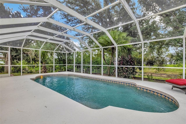 view of swimming pool featuring a lanai and a patio