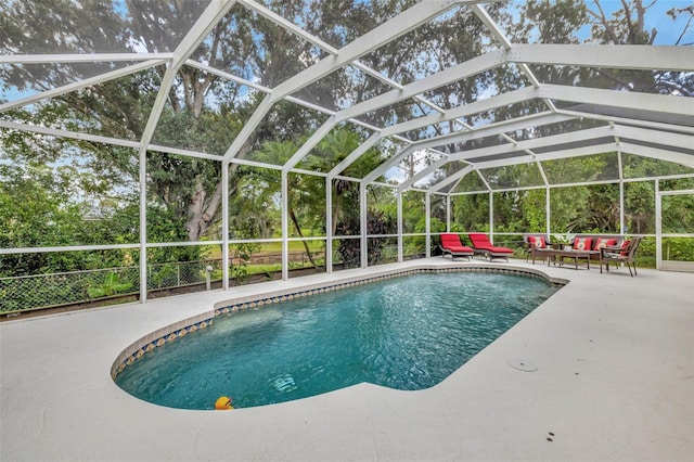 view of swimming pool with a lanai and a patio