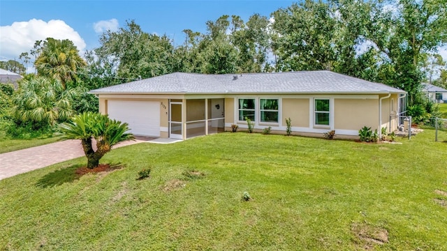 single story home featuring a garage and a front lawn