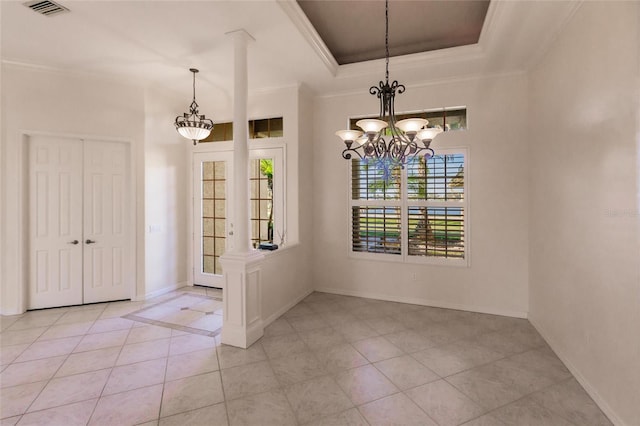 unfurnished dining area with a notable chandelier, ornamental molding, light tile patterned floors, and a tray ceiling