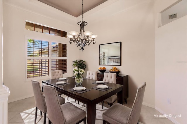 dining space featuring a notable chandelier and light tile patterned floors