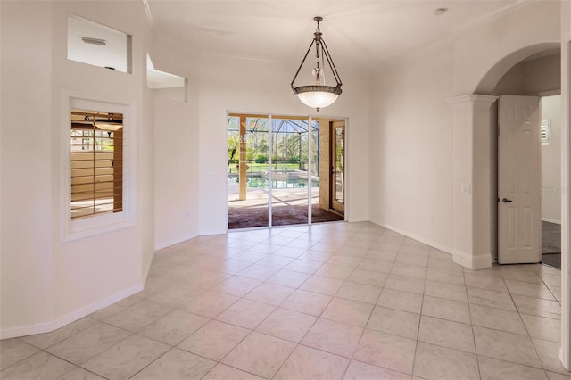 interior space with light tile patterned floors, crown molding, and a healthy amount of sunlight