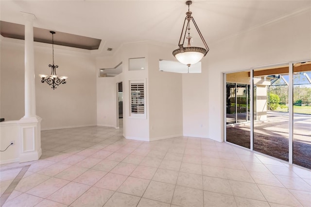 tiled spare room featuring ornate columns and crown molding