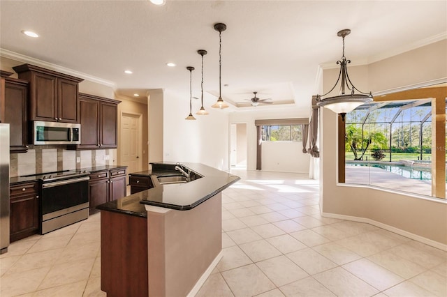 kitchen with crown molding, hanging light fixtures, ceiling fan, appliances with stainless steel finishes, and tasteful backsplash