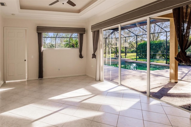 entryway featuring light tile patterned floors, a raised ceiling, ceiling fan, and ornamental molding