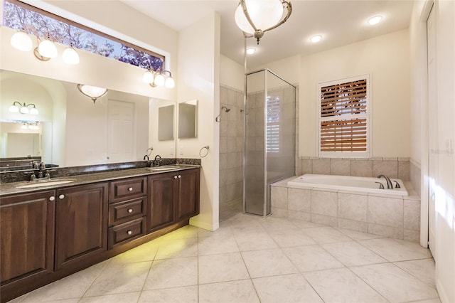 bathroom with tile patterned flooring, vanity, and independent shower and bath