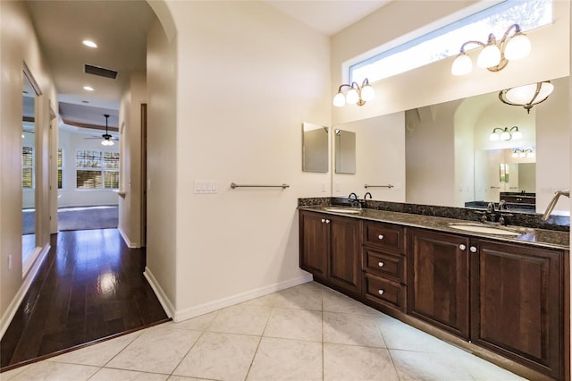 bathroom featuring hardwood / wood-style floors, vanity, ceiling fan, and a healthy amount of sunlight