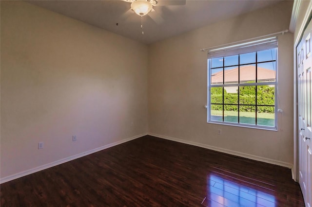 spare room featuring dark hardwood / wood-style floors and ceiling fan