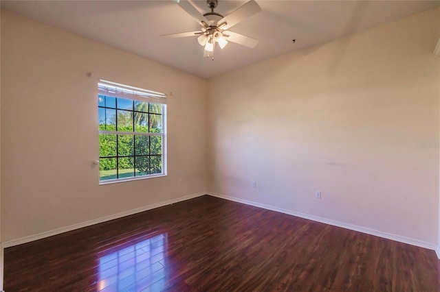 empty room with dark hardwood / wood-style flooring and ceiling fan