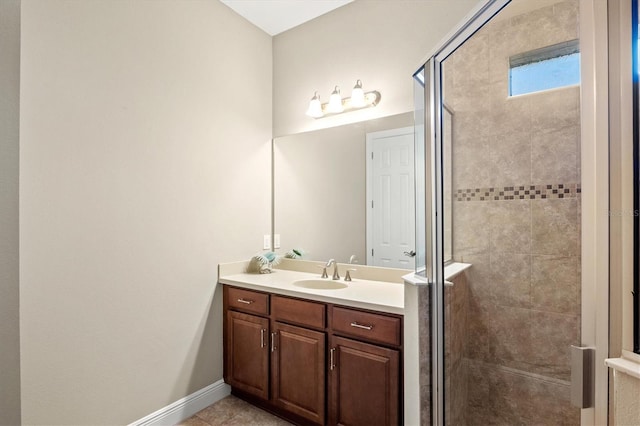 bathroom featuring tile patterned flooring, vanity, and walk in shower