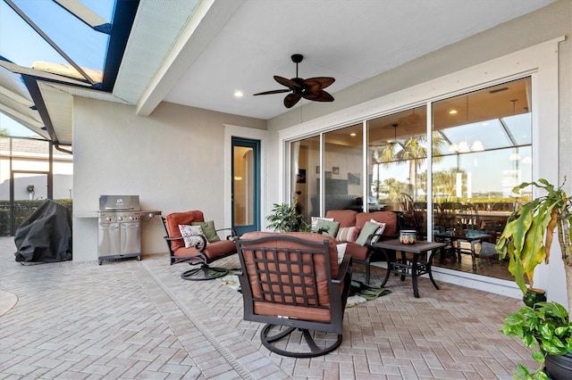 view of patio / terrace with ceiling fan, a grill, an outdoor living space, and glass enclosure