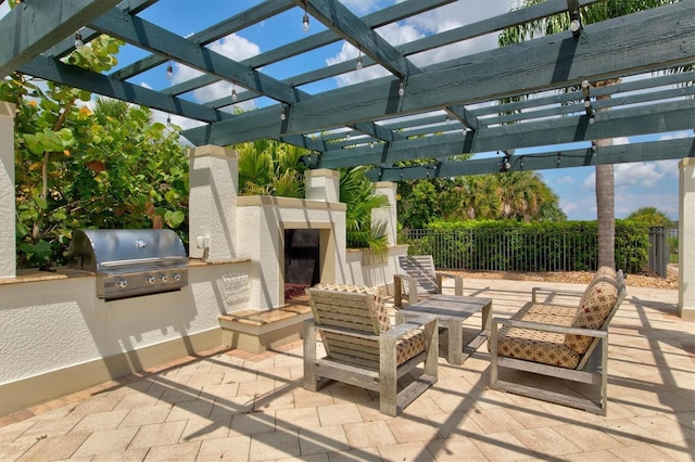 view of patio / terrace with a pergola, grilling area, and exterior kitchen