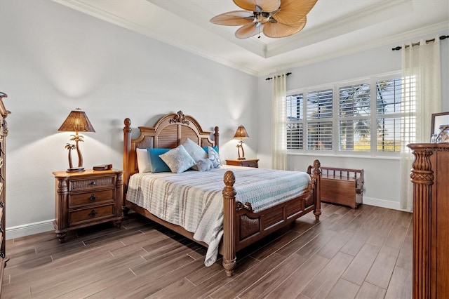 bedroom featuring a raised ceiling, ceiling fan, and crown molding