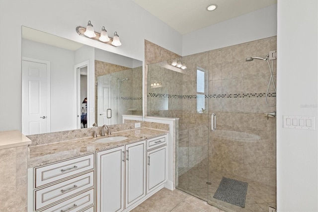 bathroom with tile patterned flooring, vanity, and a shower with shower door