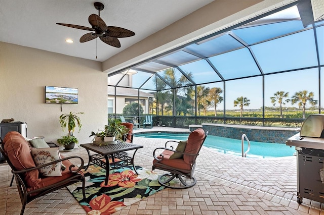 view of swimming pool with a lanai, area for grilling, ceiling fan, and a patio